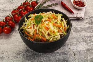 A bowl of salad with carrots and tomatoes photo