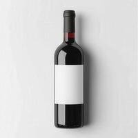 Elegant red wine bottle with blank label on white background photo