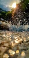 Water splashes over rocks near a sunlit riverbank photo