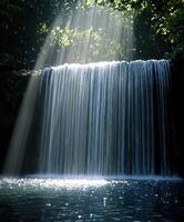 Serene waterfall glistening in sunlight surrounded by greenery photo