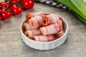 Bacon wrapped in bacon in a bowl on a table photo