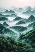 Mountainous landscape shrouded in mist at dawn photo