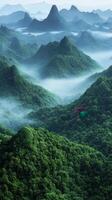 A view of the mountains and green trees photo