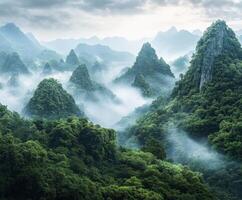 Lush green mountains under a misty sky at sunrise photo