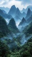 A misty mountain range with green trees and mountains photo