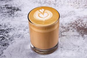 A latte with a heart design in the middle photo