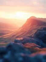 Scenic sunset over rolling hills and rocky foreground photo