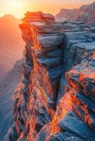 Sunset illuminates rocky cliffs in mountainous landscape photo