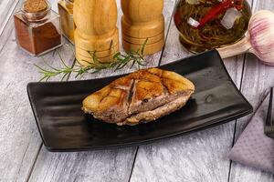 A plate of food with a piece of meat on it photo