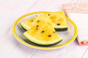 A plate with slices of watermelon on it photo