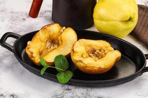 A black dish with two halves of a pear photo