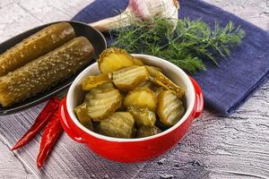 A bowl of pickles and a bowl of pickles photo