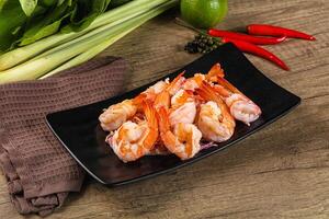 A plate of shrimp and vegetables on a table photo