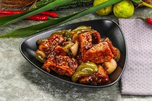 A bowl of food with peppers and onions photo