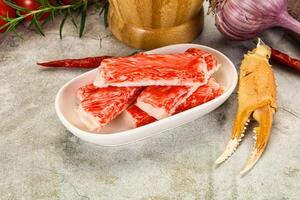 Raw crab meat in a bowl with garlic and tomatoes photo