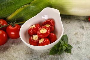A bowl filled with tomatoes and peppers photo