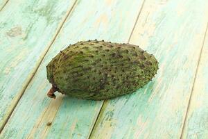 A single fruit on a wooden table photo