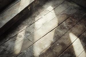 An old wooden floor with sunlight coming through the window photo