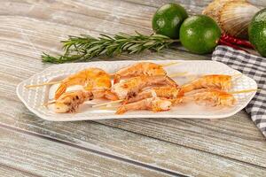 A plate with shrimp and herbs on it photo