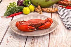 A plate with a crab on it and some vegetables photo