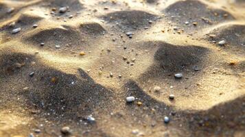 Footprints and patterns on sandy beach at sunset photo