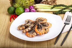 A plate of food with shrimp and vegetables photo