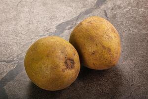 Two ripe fruits on a table photo