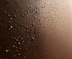 Close-up view of water droplets on dark surface photo