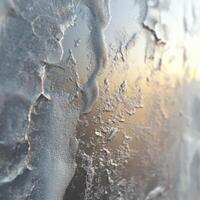 Cold frost covering a window at sunrise during winter photo