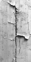 Cracked concrete wall with peeling paint in urban setting photo