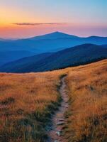 Mountain trail at sunset with vibrant sky and vast landscape photo