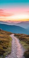 Mountain path leads to stunning sunset over valleys photo