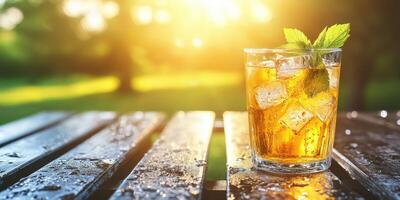 Refreshing beverage in a sunlit outdoor setting by greenery photo