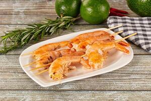 Grilled shrimp on a plate with herbs and spices photo