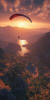 Paraglider in the sunset over a mountain range photo
