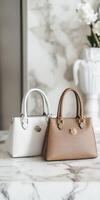 Two white handbags on a marble table photo