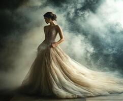 Elegant woman in flowing gown surrounded by mist photo