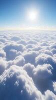 Clouds beneath a bright sun illuminating the blue sky photo