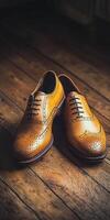 Stylish leather shoes on wooden floor with warm lighting photo
