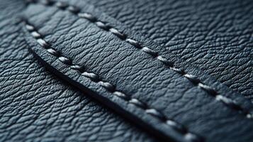 Close look at textured dark leather with detailed stitching photo