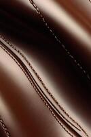 Smooth brown fabric with detailed stitching pattern photo