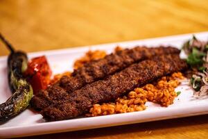 A plate with meat and rice on it photo