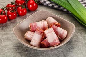 Bacon wrapped in bacon in a bowl on a table photo