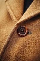 Close-up of a brown wool coat with a vintage button photo