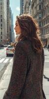 Woman in boucle fabric walking through city streets on a sunny day photo