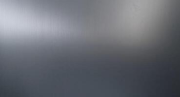 A deep graphite gray blending into a muted pewter silver brushed metal gradient background photo