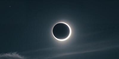 solar eclipse with a bright crescent sun visible through a partial phase. photo