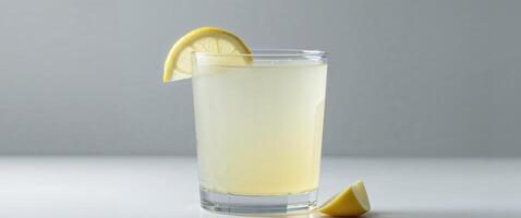 A glass of lemonade with a slice of lemon floating in it photo