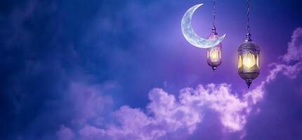 A serene night sky with a crescent moon and glowing lanterns. photo