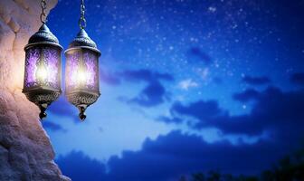Two ornate lanterns hang against a twilight sky filled with stars. photo